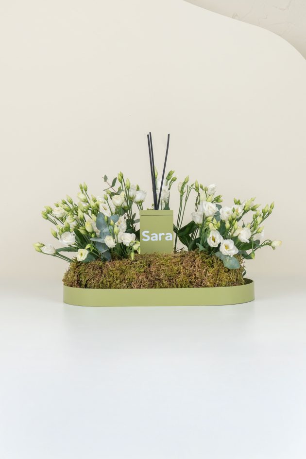 Green diffuser and white flowers